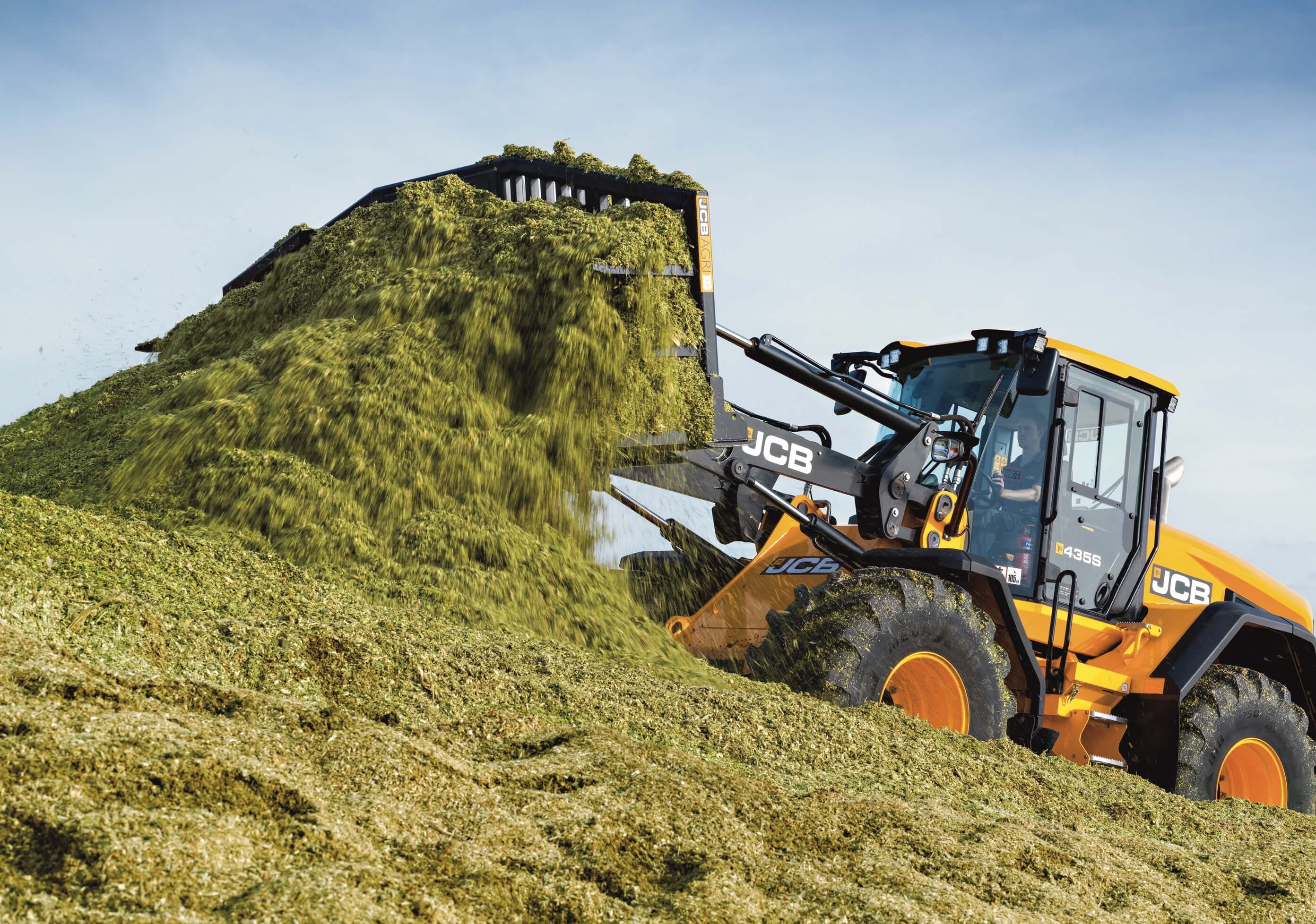 JCB machine moving grass